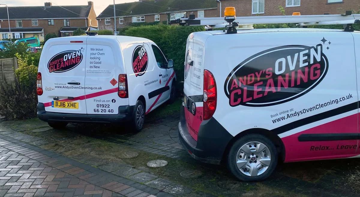 Two Andy's Oven Cleaning branded vans parked on a driveway displaying the company livery