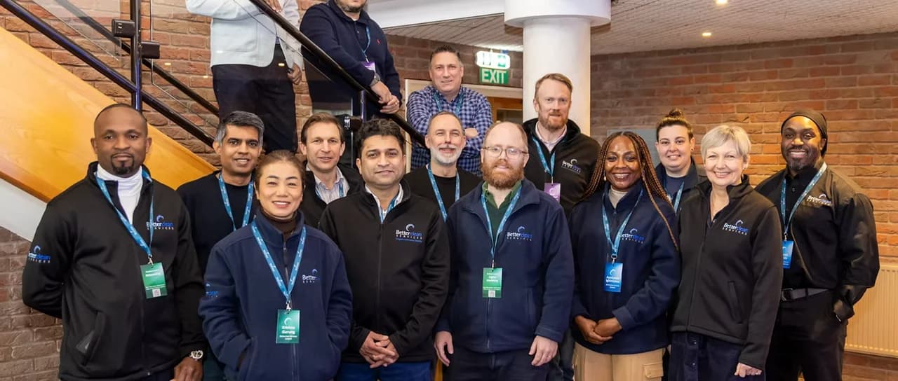 Betterclean Services franchisees and head office team posing in branded jackets and lanyards at a UK franchise event
