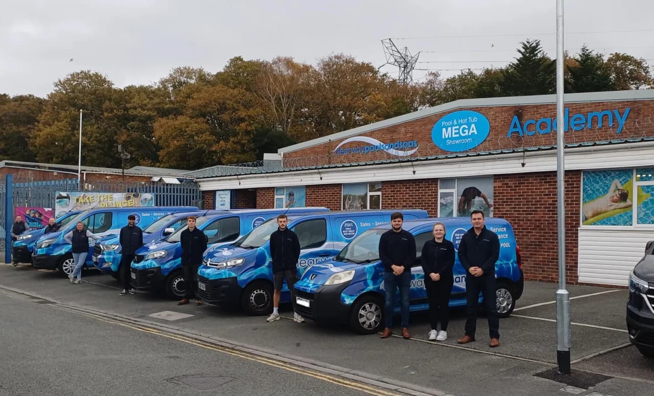 Clearway Pools and Spas franchisee team standing in front of their branded service van fleet outside the MEGA Showroom and Academy training centre