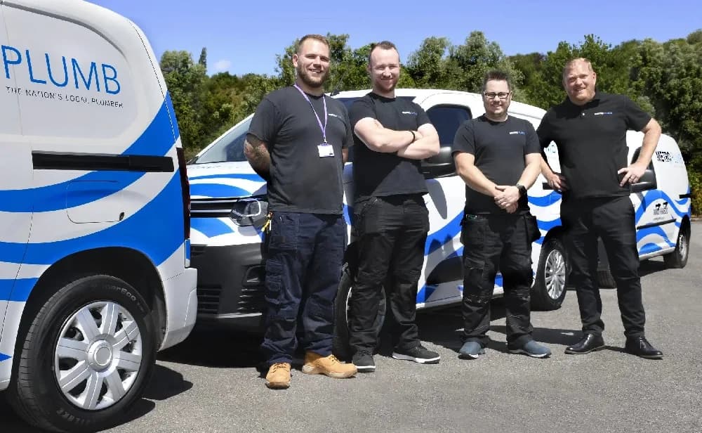Metro Plumb franchise team with branded vans serving customers across the UK