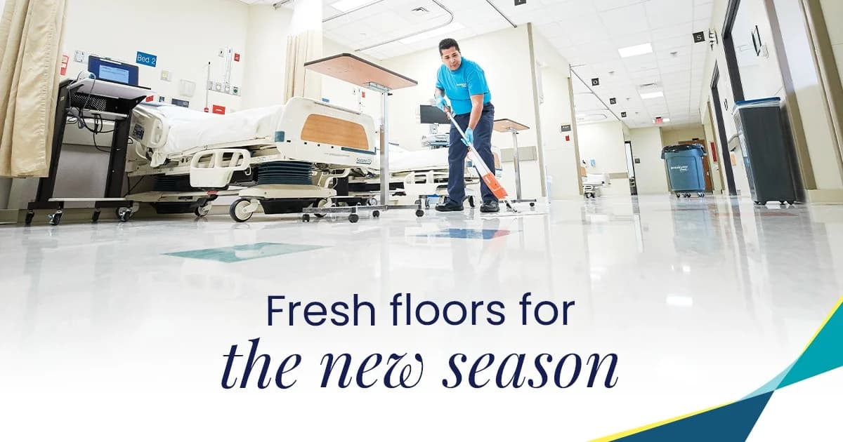 ServiceMaster Clean operative in a teal branded polo using a floor scrubber on a hospital ward floor between patient beds, with a 'Fresh floors for the new season' marketing overlay - example of the network's healthcare cleaning specialism