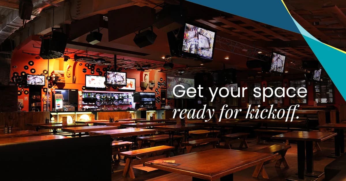 ServiceMaster Clean 'Get your space ready for kickoff' seasonal marketing visual showing a sports bar interior with rows of TVs, hanging speakers and timber tables ready for service - example of the hospitality vertical the network cleans for