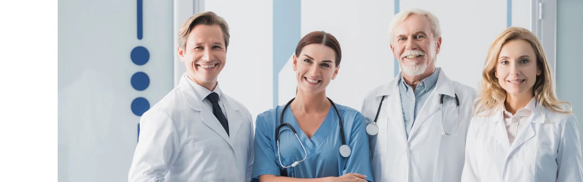 Smiling team of medical professionals in white coats and scrubs standing together in a modern clinic, representing health and beauty franchise opportunities in the UK.