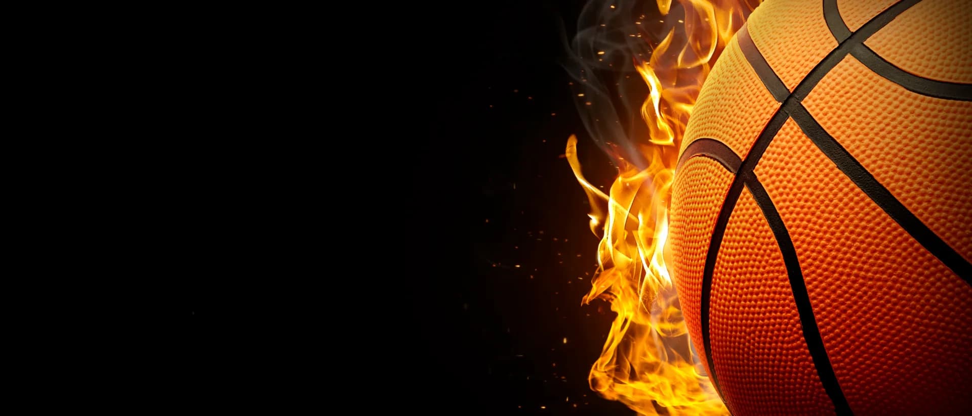 Close-up of a basketball engulfed in flames against a black background, representing sports franchise opportunities in the UK.