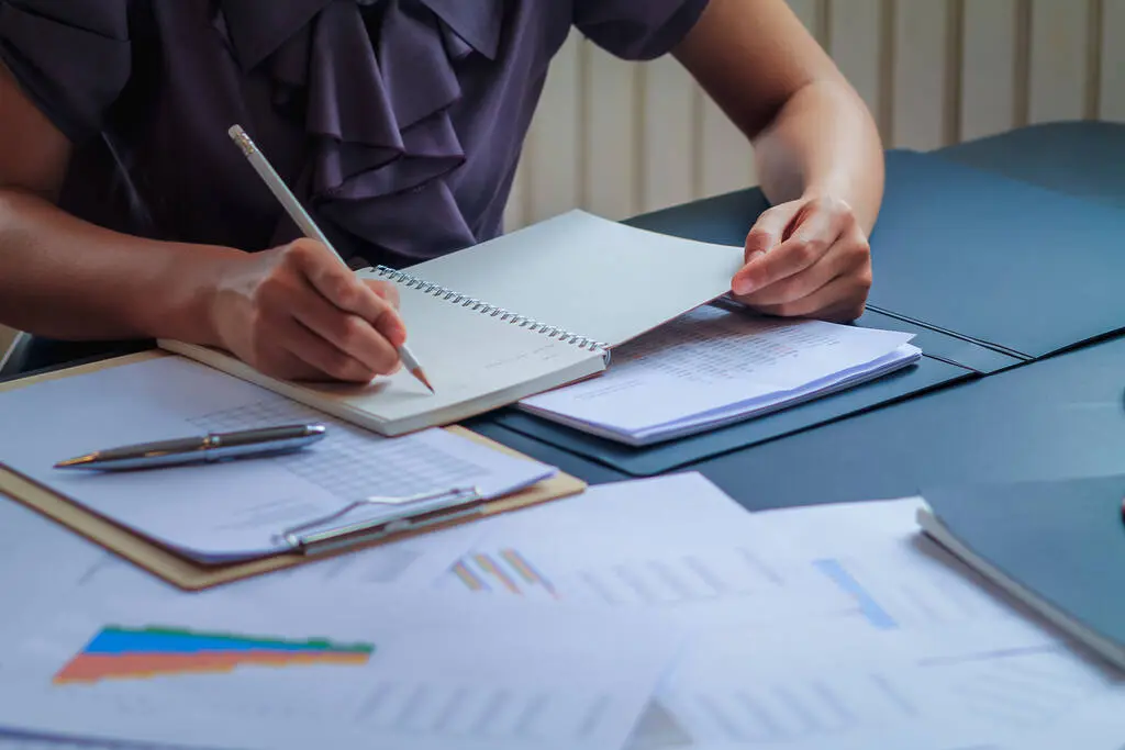 Certax Accounting Franchise owner reviewing financial documents at their office desk