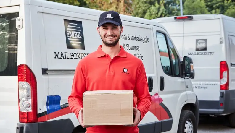 Mail Boxes Etc Franchise courier with parcel and branded delivery vans